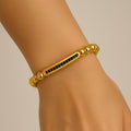 Bracelet perles dorées barre noire – Cordon ajustable | Bracelet mixte